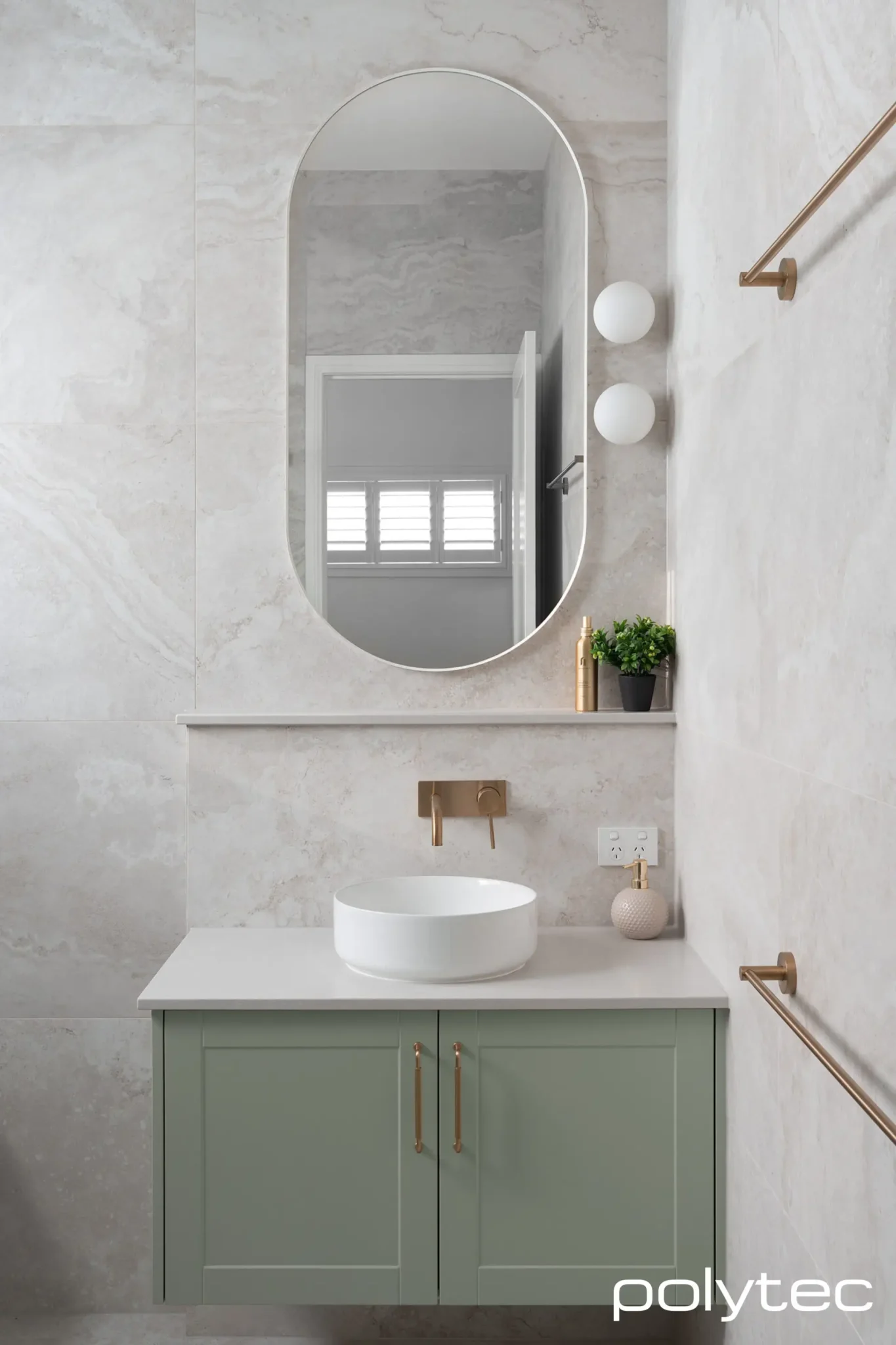 A light green bathroom vanity with a white Carrara marble countertop.