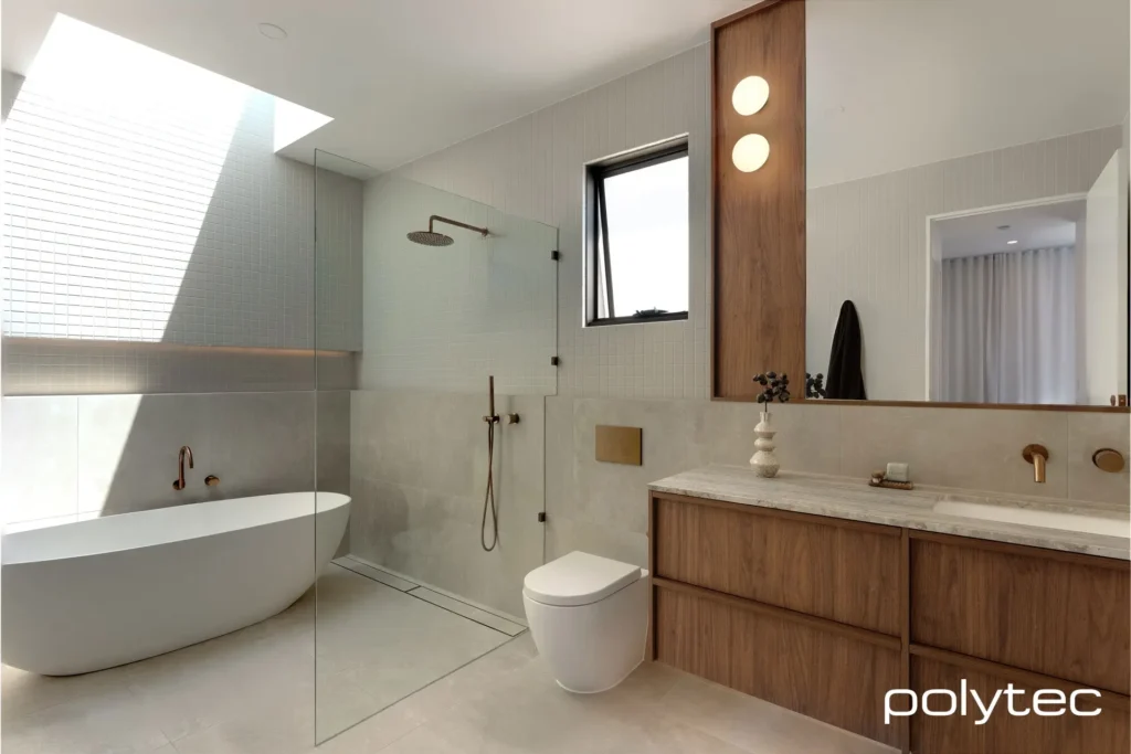 Modern bathroom featuring a bathtub, toilet, and walk-in shower with a glass door.